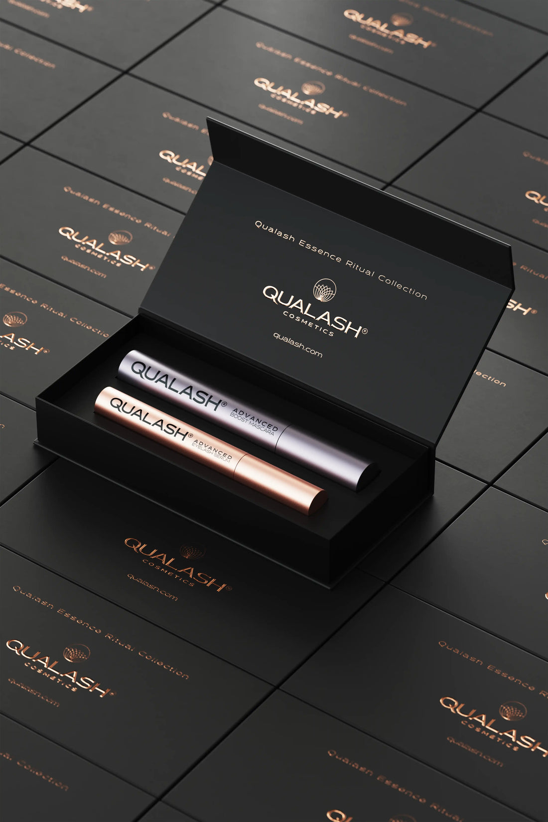 QUALASH Ritual Collection set opened on top of stacked branded gift boxes – elegant top-down perspective.